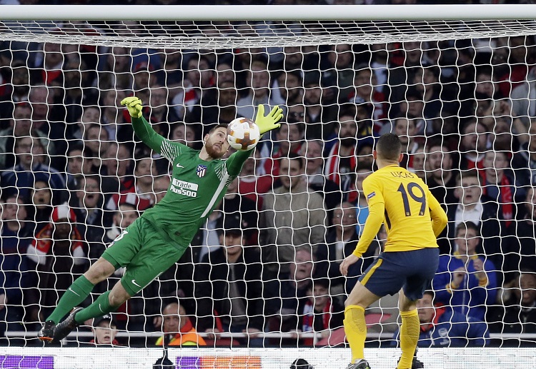 Aaron Ramsey's header was on target, but Jan Oblak claws it away to keep Atletico on level terms with Arsenal