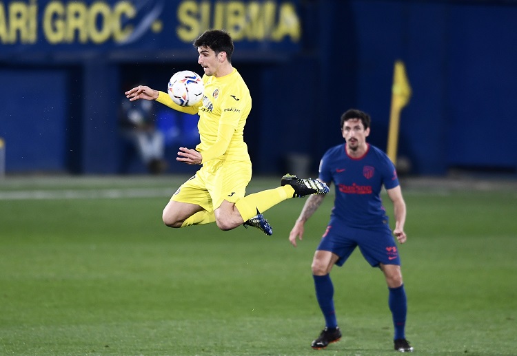 Villarreal's Gerard Moreno trying to control the ball against Atletico Madrid's Stefan Savic