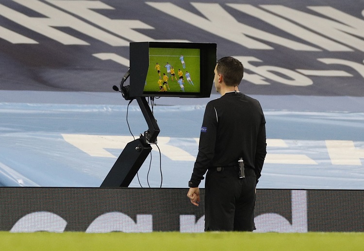 Referee Ovidiu Alin Hategan refers to the VAR for a possible penalty during the Champions League match